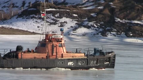 Boat breaks the ice on the River in the spring on a sunny day. Stock Footage 150122843