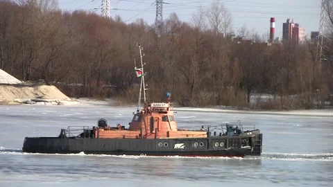 Boat breaks the ice on the River in the spring on a sunny day. Stock Footage 150122847