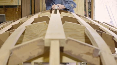 Boat builder inspecting a boat during construction Stock Footage 91704239
