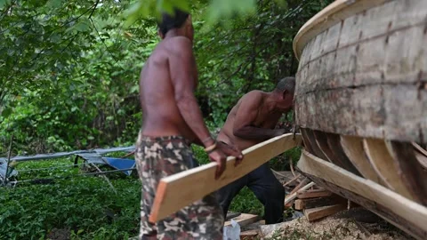Boat builders work near Klong Muang Beach Stock Footage 336717082