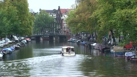 A boat in a canal in Amsterdam, Netherlands Stock Footage