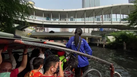 Boat carrying passengers navigate through the Bangkok canals, Thailand 4K Video stock 235609153
