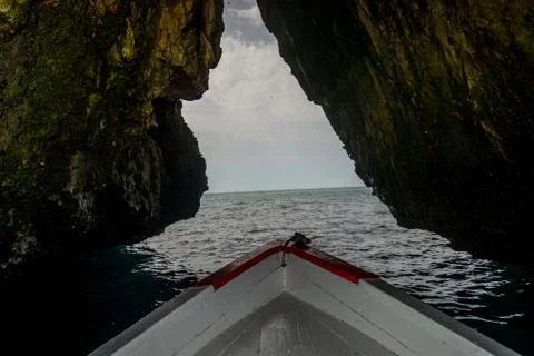 A boat in the a cave Stock Photos