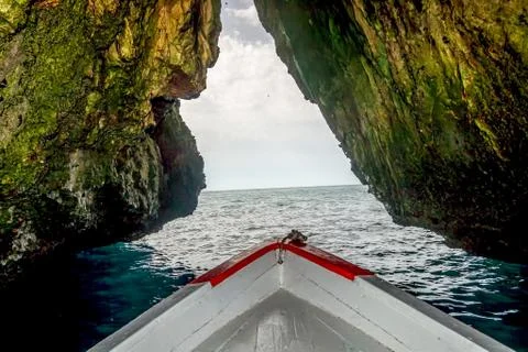 A boat in the a cave Stock Photos