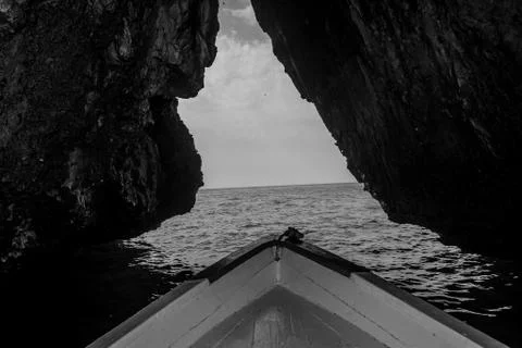 A boat in the a cave Stock Photos