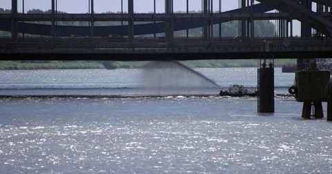 Boat is cleaning a bridge from underneath with a water jet Stock Footage 78155656