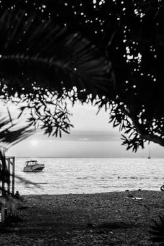 Boat off the coast at sunset Stock Photos