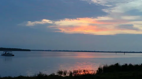 Boat coasting by under a Florida sunset Video stock 34235577