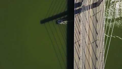 A boat comes out from under the bridge. The car moves on the bridge. Stock Footage 130497079