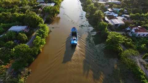 A boat cruising along a river, creating gentle water ripples Stock-Footage 340548159