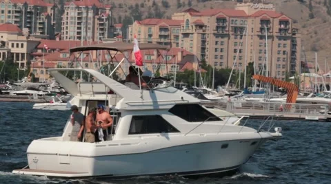 Boat crusing through the water next to city Stock Footage 44824856