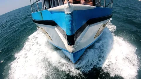 Boat cutting through waves, showcasing powerful motion and splashes Stock Footage 317784224