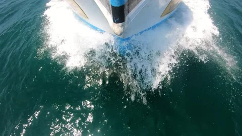 Boat cutting through waves, showcasing powerful motion and splashes, with 스톡 동영상 347869214