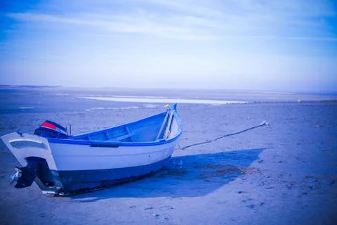 Boat on a deserted beach Stock Photos