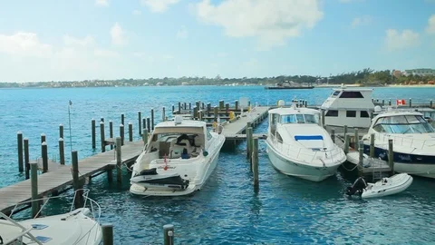 Boat dock full of ocean sea craft tied up. View from wooden pier C Stock Footage 112143641