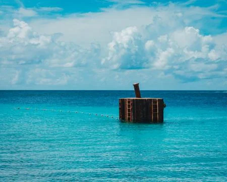 Boat dock made of cement structure in the submerged in the ocean. Stock Photos