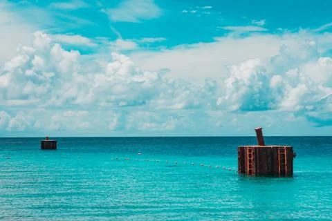 Boat dock made of cement structure in the submerged in the ocean. Stock Photos