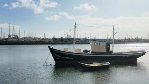 A boat docked along the Arade River in Portimão, Portugal Stock Footage 297218578