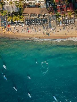 Boat doing circles in the ocean below near popular beach in Puerto Vallarta.. Stock Photos