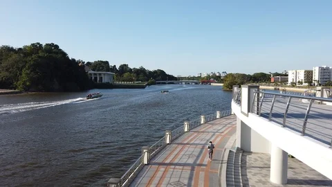 Boat down the river of Kedayan and people jogging Stock Footage 105402233