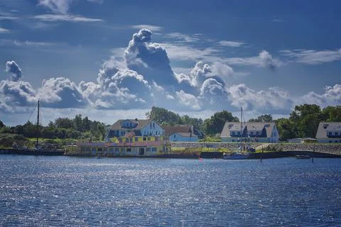 A boat with a dramatic cloud in the port of Vitte. Foto stock