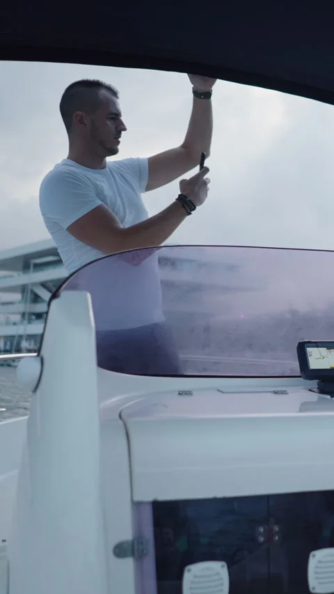 Boat driven by a bearded man next to his friend standing Stock-Footage 264926089