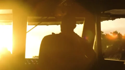 Boat driver in river at sunset Stock Footage 196447416