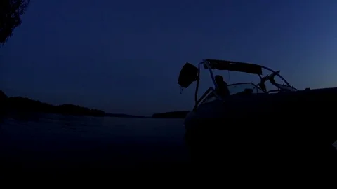 Boat driver silhouette attach the rent wakeboard to the boat and floats away Stock Footage 74951660