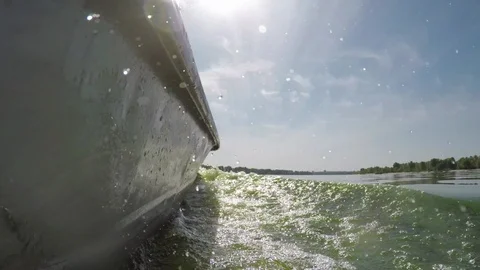 Boat driver, waves on river, splashing water, slow motion Stock Footage 94293655