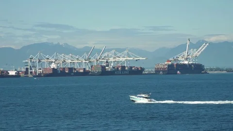 Boat Driving In Front Of Ocean Container Ships At Cranes in Habour Canada Stock Footage 80745877