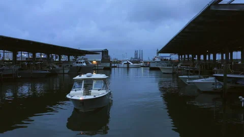 Boat driving into a harbor early cloudy morning. Video stock 237120017