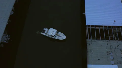 Boat driving into a harbor early cloudy morning. Video stock 237120275