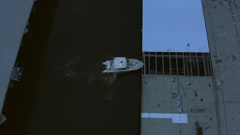 Boat driving into a harbor early cloudy morning. Video stock 237120292