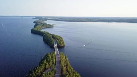 Boat driving under bridge in middle of lake Paijanne Video stock 98666653