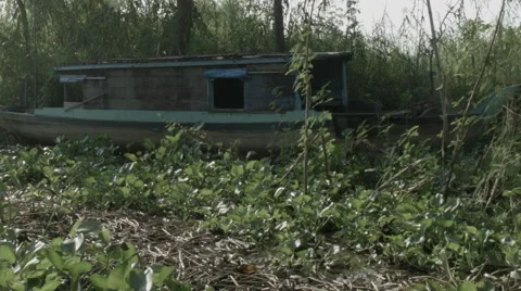A boat dry docked near a Cham village on banks of the Mekong river in Vietnam. Stock Footage 48169144