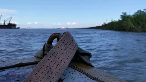 The boat edge and focus shift to the river waves in the evening. Video stock 221114401
