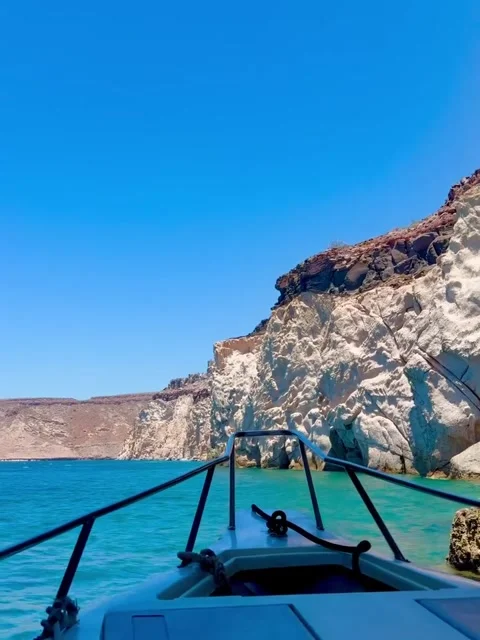 Boat Exiting Natural Rock Arch into Turquoise Water Stock Footage 340564353