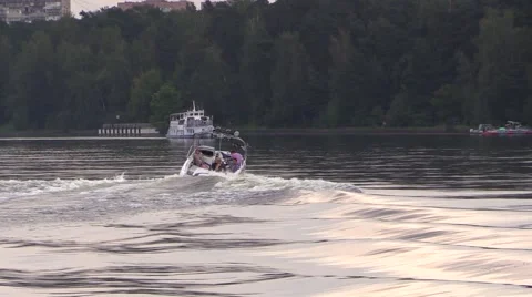 Boat float and drag water-skier by the river Stock Footage 66526319