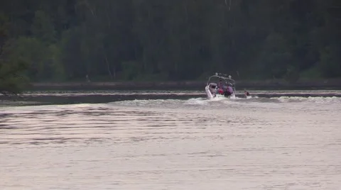 Boat float away and drag behind water-skier by the river Stock Footage 67866183