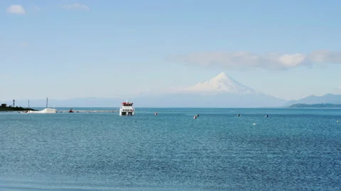 Boat floating in front of volcano in puerto varas chile Stock Footage 204876939