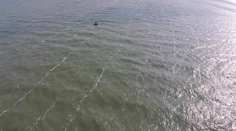 Boat floating in lake tossed by the waves aerial view Stock Footage 49724331