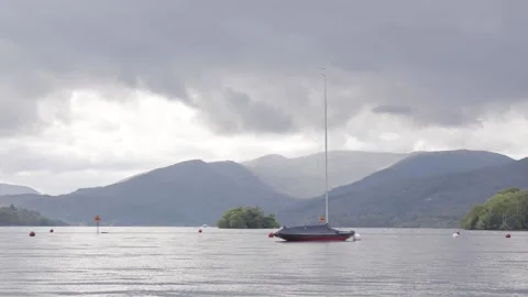 Boat floating in lake Windermere under the mountans in the lake district Stock Footage 155225920