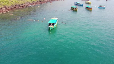 Boat Floating on the Ocean around People doing Swimming at South Goa Beach 스톡 동영상 129695845