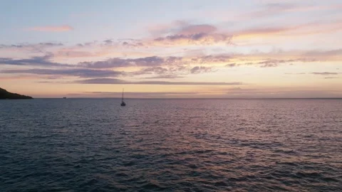 A boat is floating on the ocean at sunset Video stock 297950643