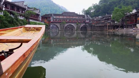 Boat floating on river in central China province. Historic town Fenghuang, Hunan Stock Footage 98736068