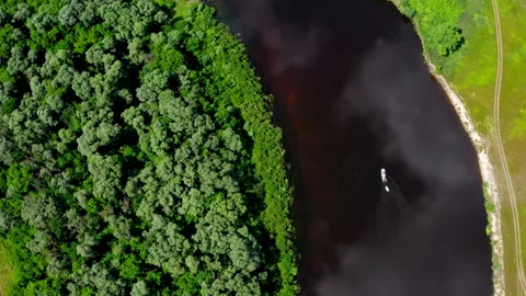 Boat is floating on the river. Drone flies  above a beautiful summer  landsca Stock Footage 198379077