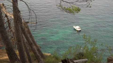 Boat floating on shallow blue Mediterranean sea. Video stock 160981854