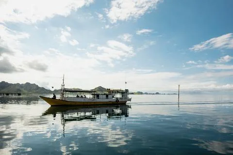 A boat floating on smooth water surface Foto stock