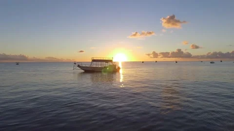 Boat floating in the sunset Stock Footage 220536835