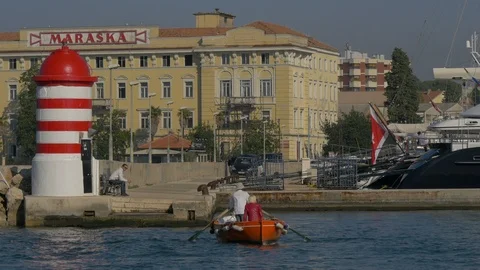 A boat floating towards a pier Stock Footage 100799766
